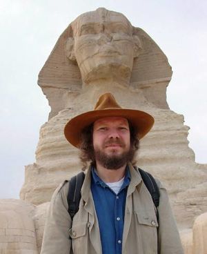 Rober Schoch standing in front of the Sphinx he claims to be much older than Egyptologist have concluded. [13]